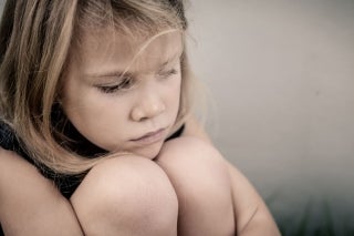 Close up of a girl hugging her knees