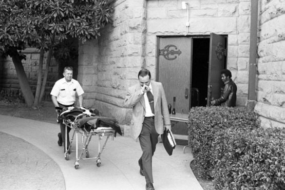 The body of Arlis Perry is wheeled to a vehicle by Santa Clara County officials. 10-13-1974