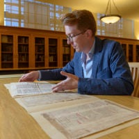 Rowan W. Dorin, assistant professor of history, with the palimpsest document.