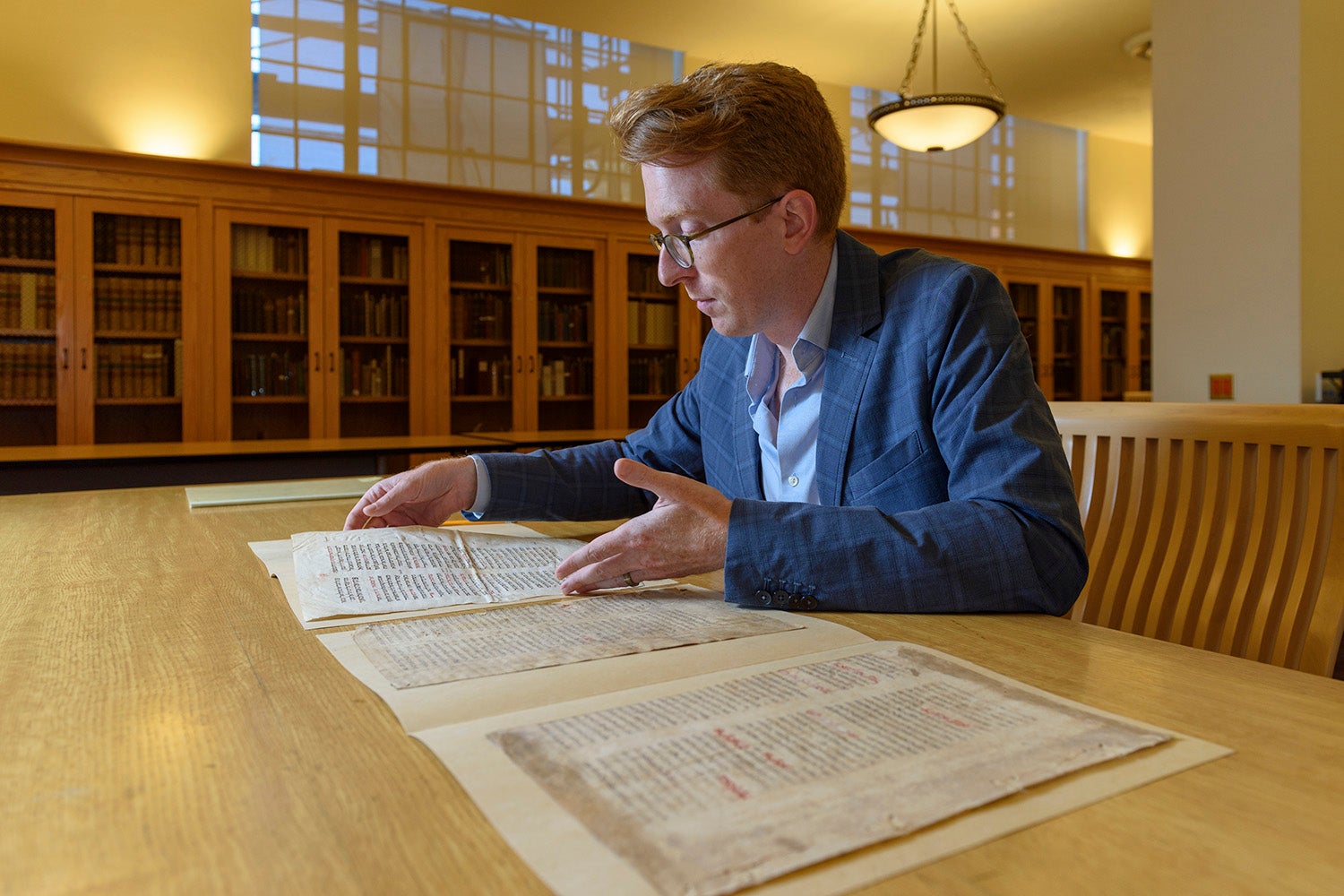 Rowan W. Dorin, assistant professor of history, with the palimpsest document.