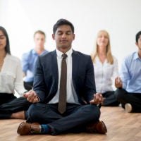 Business people meditating.