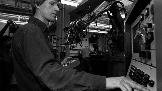 Cutkosky at a machine with a robotic arm next to him