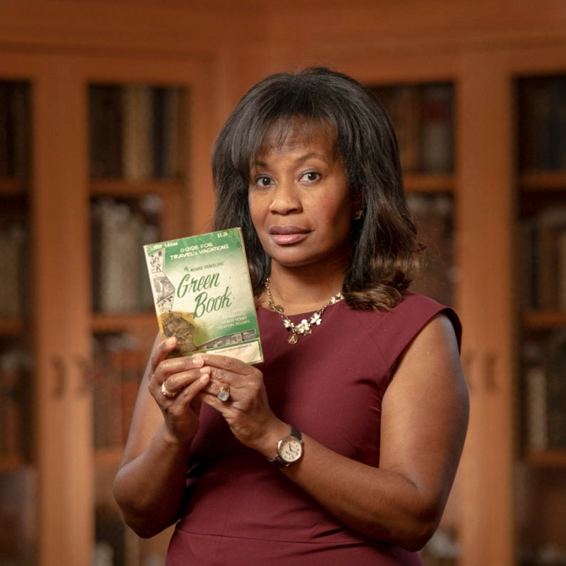 Allyson Hobbs with a copy of The Green Book from Stanford Libraries Special Collections