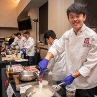 Kevin Guo, ’22, of Team Three prepares “ooo-baby pork chops” at the 16th annual Cardinal Cook-Off on Jan. 24 at the Arrillaga Family Dining Commons.
