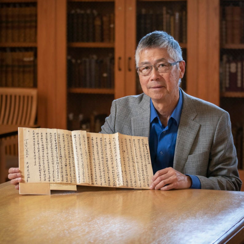 Gordon Chang with a letter from Ah Wing, reflecting on his longtime employment as the Stanford Family’s majordomo