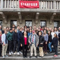 H. George Will (center, with red cap) and his wife, Sigrid (center right), join the students and staff of Stanford’s Berlin program at the H. G. Will Center.