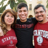 Freshman Javier Covarrubias poses for a photo with his parents in 2017