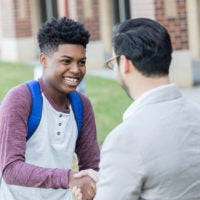 Teacher and student shake hands