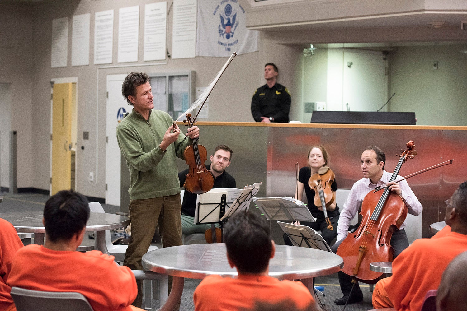 Stanford Artists-In-Residence the St. Lawrence String Quartet, play before a group of inmates at the San Francisco county jail where they performed and anwered questions about the music and their instruments. Here violinist Geoff Nuttall demonstrates the horsehair ribbon of the violin bow.