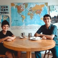 Ross Venook and his son sitting at a table with food