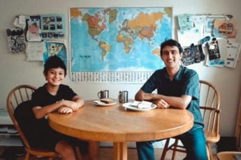 Ross Venook and his son sitting at a table with food