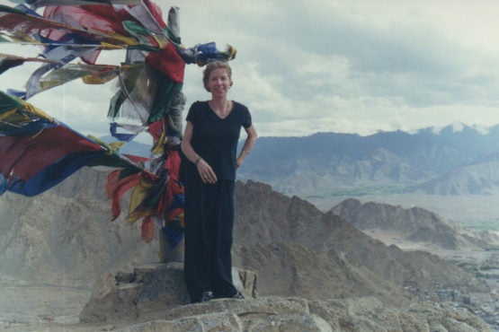 Anna Bigelow in Ladakh, India with Buddhist prayer flags in the background