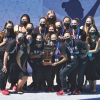 Women in masks holding trophy