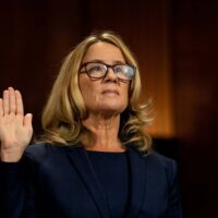 Christine Blasey Ford swears in at a Senate Judiciary Committee hearing for her to testify about sexual assault allegations against Supreme Court nominee Judge Brett M. Kavanaugh